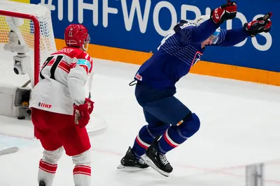 France's Justin Addamo, right, celebrates after scoring his side's third goal during the group A match between France and Denmark at the ice hockey world championship in Tampere, Finland, Sunday, May 14, 2023. (AP Photo/Pavel Golovkin)