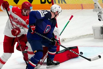 France's Justin Addamo, centre, scores his side's third goal during the group A match between France and Denmark at the ice hockey world championship in Tampere, Finland, Sunday, May 14, 2023. (AP Photo/Pavel Golovkin)