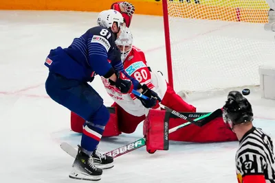 France's Anthony Rech, left, scores his side's second goal past Denmark's goalie Frederik Dichow during the group A match between France and Denmark at the ice hockey world championship in Tampere, Finland, Sunday, May 14, 2023. (AP Photo/Pavel Golovkin)