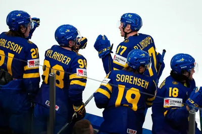 Sweden's Par Lindholm, centre, celebrates after scoring the opening goal during the group A match between Sweden and Austria at the ice hockey world championship in Tampere, Finland, Sunday, May 14, 2023. (AP Photo/Pavel Golovkin)