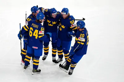 Sweden's team players celebrate after Par Lindholm, centre, scored the opening goal during the group A match between Sweden and Austria at the ice hockey world championship in Tampere, Finland, Sunday, May 14, 2023. (AP Photo/Pavel Golovkin)