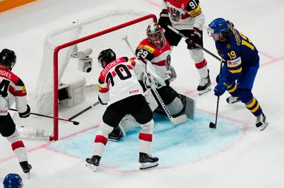 Sweden's Marcus Sorensen, right, scores his side's second goal during the group A match between Sweden and Austria at the ice hockey world championship in Tampere, Finland, Sunday, May 14, 2023. (AP Photo/Pavel Golovkin)