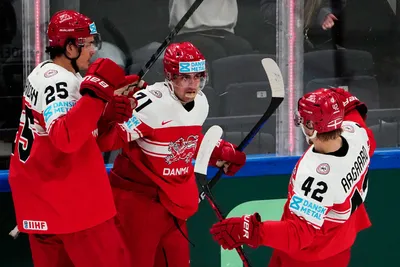 Denmark's Niklas Andersen, centre, celebrates with teammates after scoring his side's second goal during the group A match between Denmark and Austria at the ice hockey world championship in Tampere, Finland, Tuesday, May 16, 2023. (AP Photo/Pavel Golovkin)