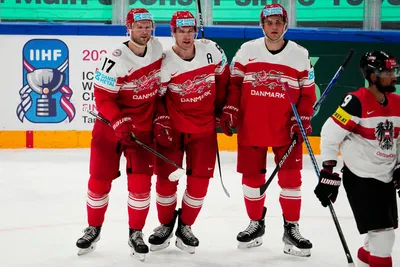 Denmark's Patrick Russell, centre, celebrates with teammates after scoring his side's sixth goal during the group A match between Denmark and Austria at the ice hockey world championship in Tampere, Finland, Tuesday, May 16, 2023. (AP Photo/Pavel Golovkin)
