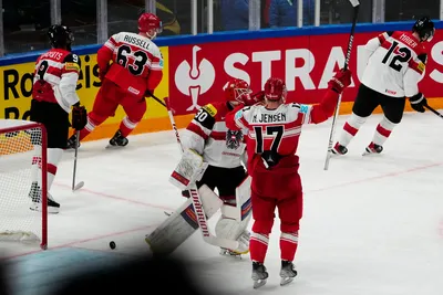 Denmark's Patrick Russell, top, celebrates after scoring his side's sixth goal during the group A match between Denmark and Austria at the ice hockey world championship in Tampere, Finland, Tuesday, May 16, 2023. (AP Photo/Pavel Golovkin)