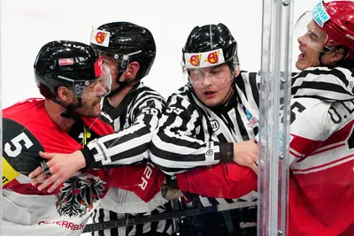 Denmark's Oliver Lauridsen, right, and Austria's Thomas Raffl, left, argue during the group A match between Denmark and Austria at the ice hockey world championship in Tampere, Finland, Tuesday, May 16, 2023. (AP Photo/Pavel Golovkin)