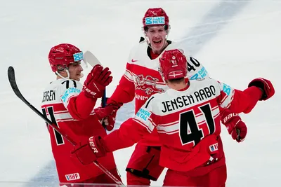 Denmark's Jesper Jensen Aabo, right back to the camera, celebrates with teammates after scoring his side's third goal during the group A match between Denmark and Austria at the ice hockey world championship in Tampere, Finland, Tuesday, May 16, 2023. (AP Photo/Pavel Golovkin)