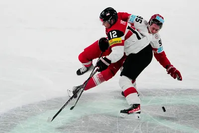 Denmark's Nick Olesen, top, and Austria's David Maier battle for the puck during the group A match between Denmark and Austria at the ice hockey world championship in Tampere, Finland, Tuesday, May 16, 2023. (AP Photo/Pavel Golovkin)