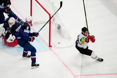 Hungary's Vilmos Gallo, right, celebrates after scoring his side's second goal past France's goalie Sebastian Ylonen during the group A match between France and Hungary at the ice hockey world championship in Tampere, Finland, Tuesday, May 16, 2023. (AP Photo/Pavel Golovkin)