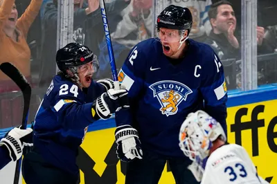 Finland's Marko Antilla, centre right, celebrates with Finland's Hannes Bjorninen after scoring his side's third goal during the group A match between Finland and France at the ice hockey world championship in Tampere, Finland, Wednesday, May 17, 2023. (AP Photo/Pavel Golovkin)