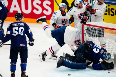 France's Justin Addamo, centre, celebrates after scoring his side's second goal past Finland's goalie Emil Larmi, bottom right, during the group A match between Finland and France at the ice hockey world championship in Tampere, Finland, Wednesday, May 17, 2023. (AP Photo/Pavel Golovkin)