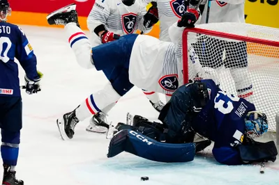 France's Justin Addamo, centre, celebrates after scoring his side's second goal past Finland's goalie Emil Larmi, bottom right, during the group A match between Finland and France at the ice hockey world championship in Tampere, Finland, Wednesday, May 17, 2023. (AP Photo/Pavel Golovkin)