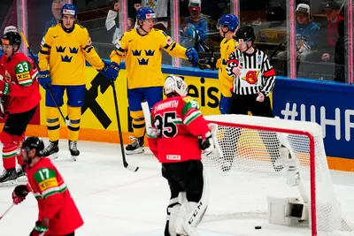 Sweden's Jonatan Berggren, top centre left, celebrates with teammates after scoring his side's fifth goal during the group A match between Hungary and Sweden at the ice hockey world championship in Tampere, Finland, Thursday, May 18, 2023. (AP Photo/Pavel Golovkin)