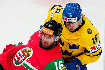 Hungary's Daniel Koger, left, and Sweden's Marcus Sorensen battle for the puck during the group A match between Hungary and Sweden at the ice hockey world championship in Tampere, Finland, Thursday, May 18, 2023. (AP Photo/Pavel Golovkin)