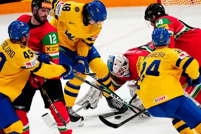 Sweden's Dennis Everberg, centre, tries to score past Hungary's goalie Dominik Horvath during the group A match between Hungary and Sweden at the ice hockey world championship in Tampere, Finland, Thursday, May 18, 2023. (AP Photo/Pavel Golovkin)