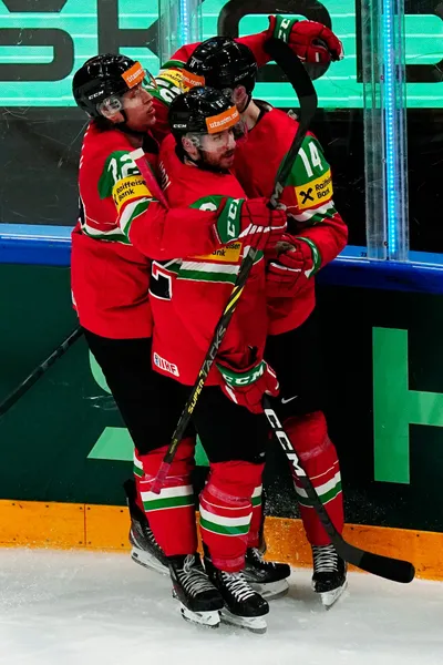 Hungary's Balazs Sebok, tight, celebrates with Vilmos Gallo, left, and Janos Hari after scoring his side's first goal during the group A match between Hungary and Finland at the ice hockey world championship in Tampere, Finland, Friday, May 19, 2023. (AP Photo/Pavel Golovkin)