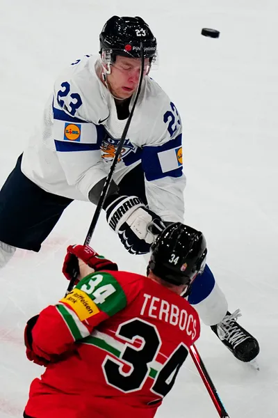 Finland's Nikolas Matinpalo, top, and Hungary's Istvan Terbocs battle for the puck during the group A match between Hungary and Finland at the ice hockey world championship in Tampere, Finland, Friday, May 19, 2023. (AP Photo/Pavel Golovkin)