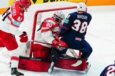 United States Patrick Brown, right, tries to score past Denmark's goalie Frederik Dichow during the group A match between United States and Denmark at the ice hockey world championship in Tampere, Finland, Saturday, May 20, 2023. (AP Photo/Pavel Golovkin)
