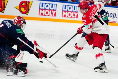 Denmark's Oscar Moelgaard, right, tries to score past United States goalie Casey DeSmith during the group A match between United States and Denmark at the ice hockey world championship in Tampere, Finland, Saturday, May 20, 2023. (AP Photo/Pavel Golovkin)