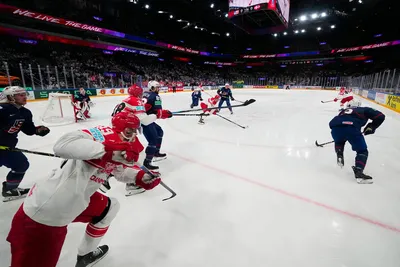 Players battle for the puck during the group A match between United States and Denmark at the ice hockey world championship in Tampere, Finland, Saturday, May 20, 2023. (AP Photo/Pavel Golovkin)