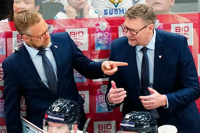 Finland's head coach Jukka Jalonen, right, and assistant coach Mikko Manner talk to players during the group A match between Austria and Finland at the ice hockey world championship in Tampere, Finland, Saturday, May 20, 2023. (AP Photo/Pavel Golovkin)
