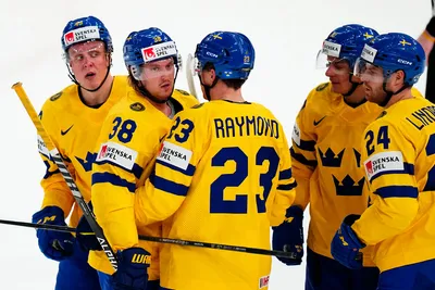 Sweden's Fabian Zetterlund, left, celebrates with teammates after scoring his side's fourth goal during the group A match between Sweden and France at the ice hockey world championship in Tampere, Finland, Saturday, May 20, 2023. (AP Photo/Pavel Golovkin)