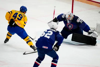 Sweden's Fabian Zetterlund, left, scores his side's second goal past France's goalie Julian Junca during the group A match between Sweden and France at the ice hockey world championship in Tampere, Finland, Saturday, May 20, 2023. (AP Photo/Pavel Golovkin)