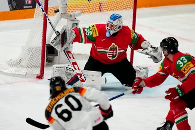 Germany's Wojciech Stachowiak, left, scores the opening goal past Hungary's goalie Dominik Horvath during the group A match between Germany and Hungary at the ice hockey world championship in Tampere, Finland, Sunday, May 21, 2023. (AP Photo/Pavel Golovkin)