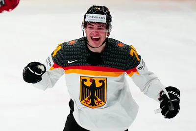 Germany's Justin Schutz celebrates after Wojciech Stachowiak scored the opening goal during the group A match between Germany and Hungary at the ice hockey world championship in Tampere, Finland, Sunday, May 21, 2023. (AP Photo/Pavel Golovkin)