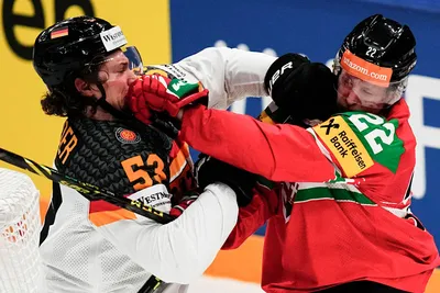 Germany's Moritz Seider, left, and Hungary's Vilmos Gallo argue during the group A match between Germany and Hungary at the ice hockey world championship in Tampere, Finland, Sunday, May 21, 2023. (AP Photo/Pavel Golovkin)