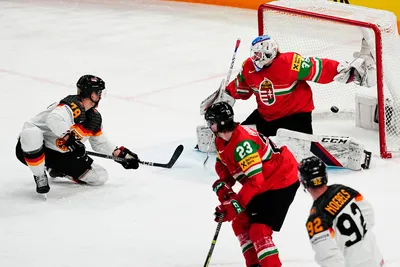 Germany's Nico Sturm, left, scores his side's fourth goal past Hungary's goalie Dominik Horvath during the group A match between Germany and Hungary at the ice hockey world championship in Tampere, Finland, Sunday, May 21, 2023. (AP Photo/Pavel Golovkin)