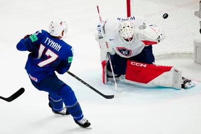 United States T J Tynan, left, scores his side's third goal past France's goalie Sebastian Ylonen during the group A match between United States and France at the ice hockey world championship in Tampere, Finland, Sunday, May 21, 2023. (AP Photo/Pavel Golovkin)
