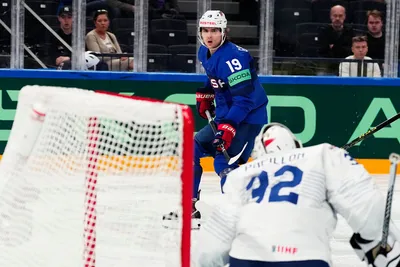 United States Cutter Gauthier, top, scores his side's fourth goal past France's goalie Quentin Papillon during the group A match between United States and France at the ice hockey world championship in Tampere, Finland, Sunday, May 21, 2023. (AP Photo/Pavel Golovkin)