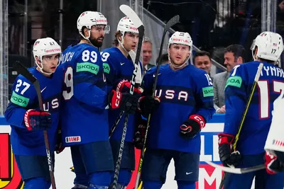United States Cutter Gauthier, centre, celebrates with teammates after scoring his side's fourth goal during the group A match between United States and France at the ice hockey world championship in Tampere, Finland, Sunday, May 21, 2023. (AP Photo/Pavel Golovkin)