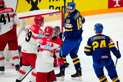 Sweden's Dennis Everberg, centre, celebrates after scoring his side's first goal during the group A match between Denmark and Sweden at the ice hockey world championship in Tampere, Finland, Monday, May 22, 2023. (AP Photo/Pavel Golovkin)