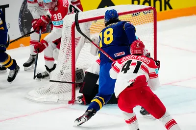 Sweden's Dennis Everberg, centre, scores his side's first goal during the group A match between Denmark and Sweden at the ice hockey world championship in Tampere, Finland, Monday, May 22, 2023. (AP Photo/Pavel Golovkin)