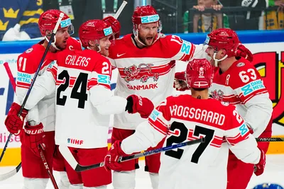 Denmark's Nicklas Jensen, centre, celebrates with teammates after scoring the opening goal during the group A match between Denmark and Sweden at the ice hockey world championship in Tampere, Finland, Monday, May 22, 2023. (AP Photo/Pavel Golovkin)