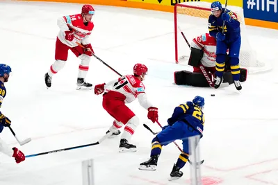 Sweden's Andre Petersson, bottom, scores his side's second goal past Denmark's goalie George Sorensen during the group A match between Denmark and Sweden at the ice hockey world championship in Tampere, Finland, Monday, May 22, 2023. (AP Photo/Pavel Golovkin)