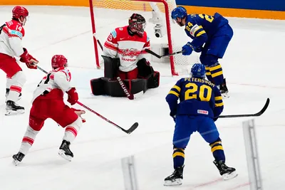 Sweden's Andre Petersson, bottom right, scores his side's second goal past Denmark's goalie George Sorensen during the group A match between Denmark and Sweden at the ice hockey world championship in Tampere, Finland, Monday, May 22, 2023. (AP Photo/Pavel Golovkin)