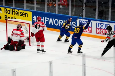 Sweden's Andre Petersson, centre right, celebrates with Oscar Lindberg, centre, after scoring his side's second goal past Denmark's goalie George Sorensen, left, during the group A match between Denmark and Sweden at the ice hockey world championship in Tampere, Finland, Monday, May 22, 2023. (AP Photo/Pavel Golovkin)