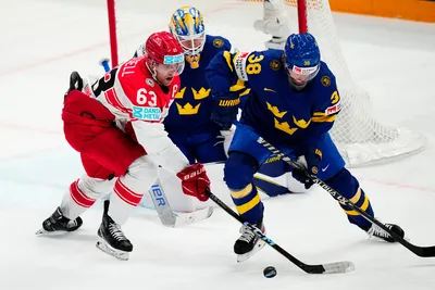 Sweden's Rasmus Sandin, right, and Denmark's Patrick Russell battle for the puck during the group A match between Denmark and Sweden at the ice hockey world championship in Tampere, Finland, Monday, May 22, 2023. (AP Photo/Pavel Golovkin)