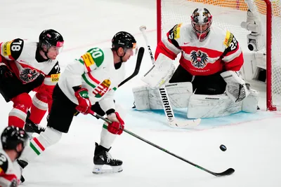 Hungary's Istvan Sofron, centre, scores his side's second goal past Austria's goalie Bernhard Starkbaum during the group A match between Austria and Hungary at the ice hockey world championship in Tampere, Finland, Monday, May 22, 2023. (AP Photo/Pavel Golovkin)