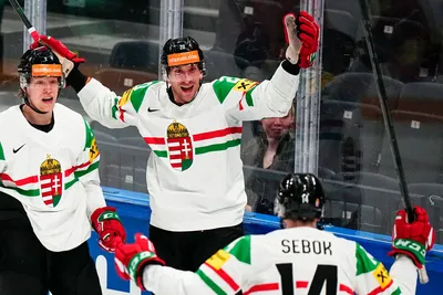 Hungary's Istvan Sofron, centre, celebrates with teammates after scoring his side's second goal during the group A match between Austria and Hungary at the ice hockey world championship in Tampere, Finland, Monday, May 22, 2023. (AP Photo/Pavel Golovkin)