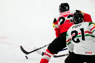 Austria's Marco Rossi, left, scores his side's first goal during the group A match between Austria and Hungary at the ice hockey world championship in Tampere, Finland, Monday, May 22, 2023. (AP Photo/Pavel Golovkin)