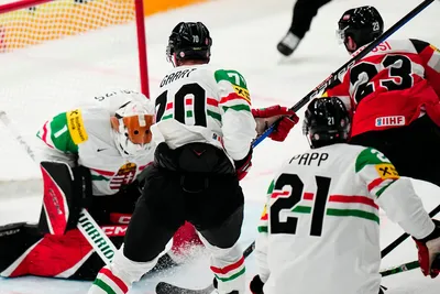 Austria's Marco Rossi, right, scores his side's first goal during the group A match between Austria and Hungary at the ice hockey world championship in Tampere, Finland, Monday, May 22, 2023. (AP Photo/Pavel Golovkin)
