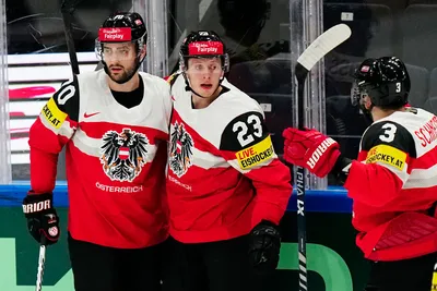 Austria's Marco Rossi, centre, celebrates with teammates after scoring his side's first goal during the group A match between Austria and Hungary at the ice hockey world championship in Tampere, Finland, Monday, May 22, 2023. (AP Photo/Pavel Golovkin)