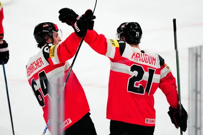Austria's Lukas Haudum, right, celebrates with David Reinbacher after scoring his side's third goal during the group A match between Austria and Hungary at the ice hockey world championship in Tampere, Finland, Monday, May 22, 2023. (AP Photo/Pavel Golovkin)