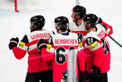 Austria's Lukas Haudum, right, celebrates with teammates after scoring his side's third goal during the group A match between Austria and Hungary at the ice hockey world championship in Tampere, Finland, Monday, May 22, 2023. (AP Photo/Pavel Golovkin)