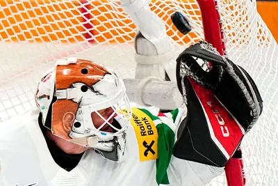 Hungary's goalie Bence Balizs fails to save Austria's side's third goal by Lukas Haudum during the group A match between Austria and Hungary at the ice hockey world championship in Tampere, Finland, Monday, May 22, 2023. (AP Photo/Pavel Golovkin)