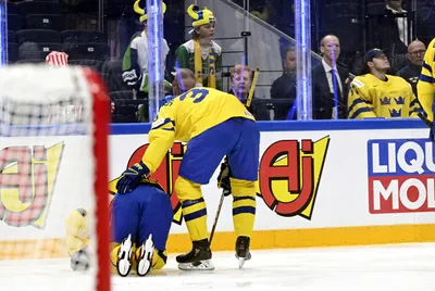 Rasmus Sandin of Sweden, left, is helped by a teammate as he gets injured during the 2023 IIHF Ice Hockey World Championships preliminary round group A match between Sweden and USA in Tampere, Finland, Tuesday, May 23, 2023. (Emmi Korhonen/Lehtikuva via AP)

- .